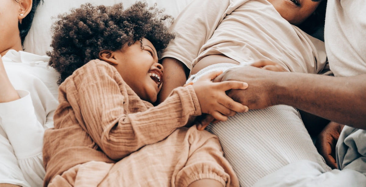 happy child in bed frame